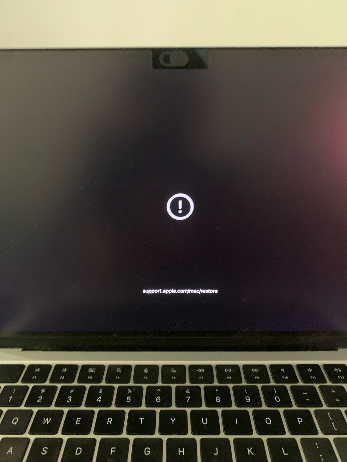 A MacBook on the macOS recovery screen